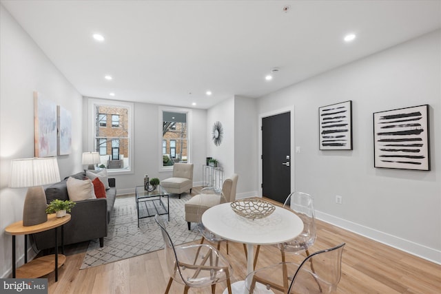 dining space featuring light wood-style flooring, baseboards, and recessed lighting