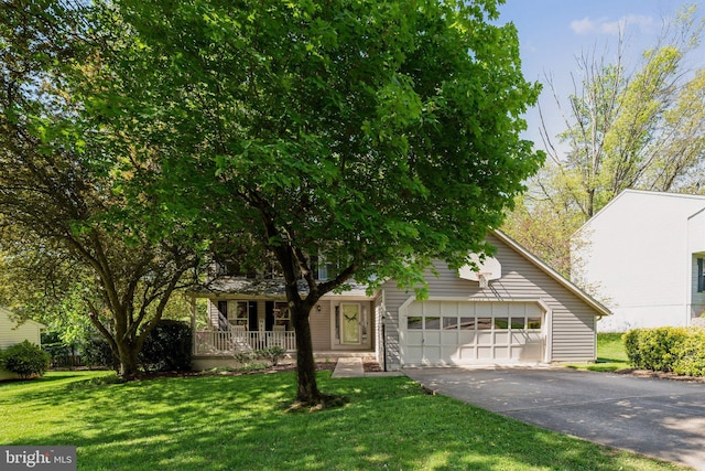 obstructed view of property featuring a garage, a front lawn, a porch, and driveway