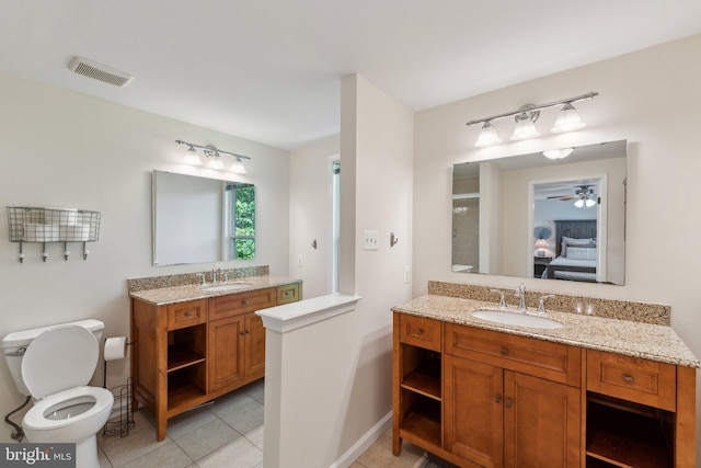 full bath with toilet, tile patterned floors, visible vents, and a sink