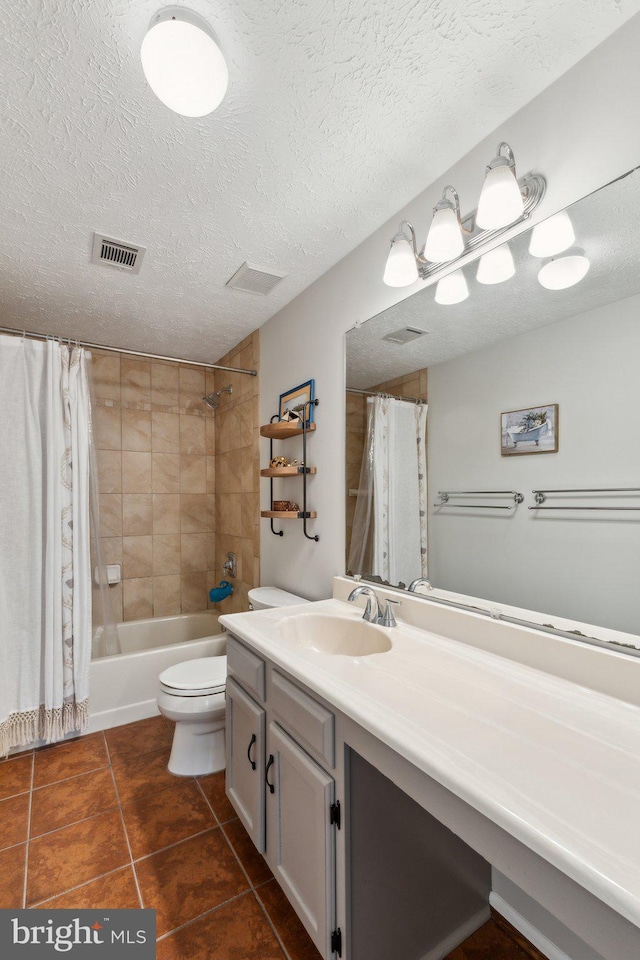 full bathroom featuring a textured ceiling, visible vents, tile patterned floors, vanity, and toilet