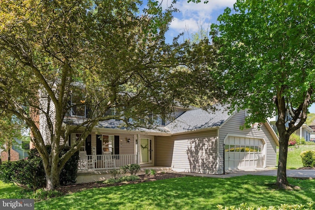 view of front facade featuring a shingled roof, an attached garage, aphalt driveway, a porch, and a front yard