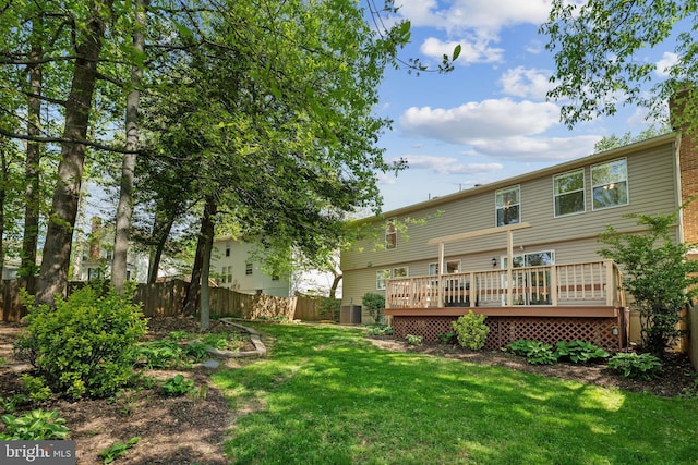 rear view of house with a fenced backyard, central air condition unit, a yard, and a deck