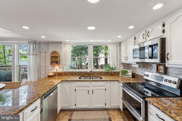 kitchen featuring a sink, white cabinets, and stainless steel appliances