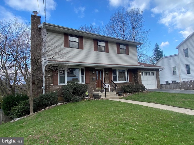 2060 Mahantongo St, Pottsville, PA 17901 - traditional home featuring a garage, a chimney, aphalt driveway, brick siding, and a front lawn