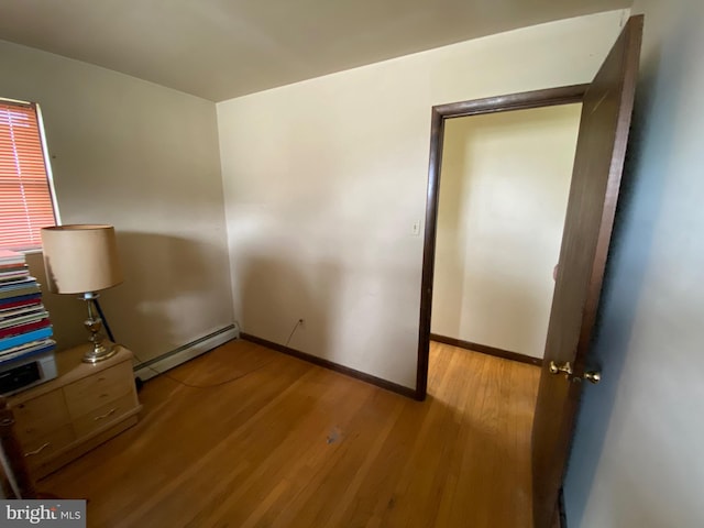 2060 Mahantongo St, Pottsville, PA 17901 - unfurnished bedroom with wood finished floors, a baseboard heating unit, and baseboards