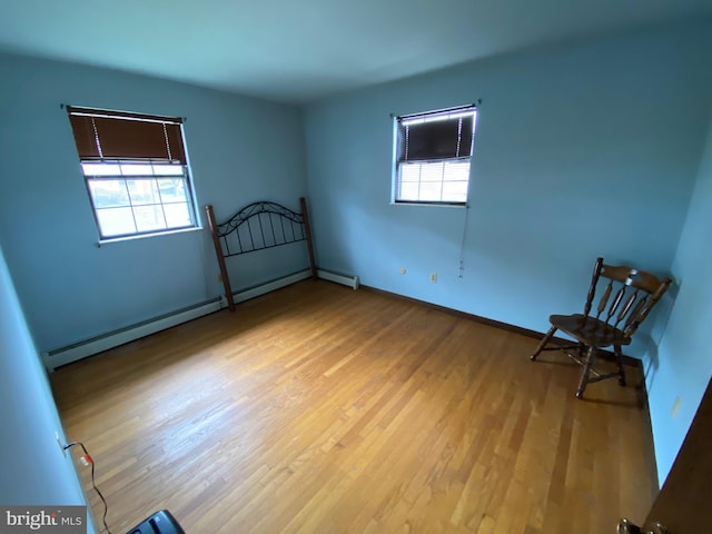 2060 Mahantongo St, Pottsville, PA 17901 - empty room with baseboard heating, wood finished floors, and baseboards