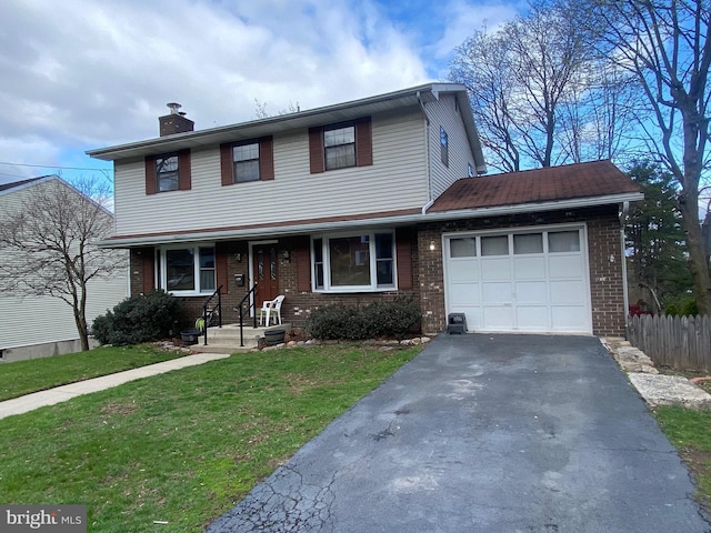 2060 Mahantongo St, Pottsville, PA 17901 - traditional-style house featuring fence, brick siding, an attached garage, a chimney, and driveway