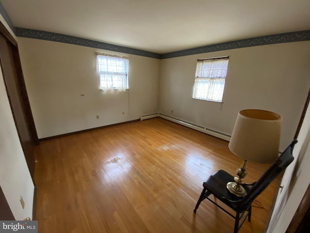 2060 Mahantongo St, Pottsville, PA 17901 - unfurnished bedroom with a baseboard radiator, wood finished floors, baseboards, and multiple windows