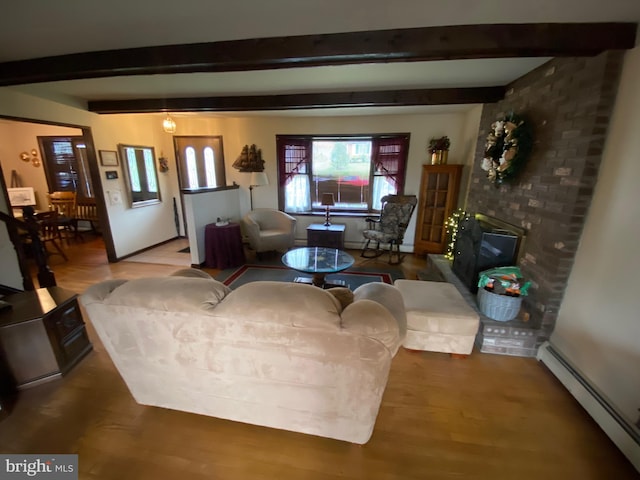 2060 Mahantongo St, Pottsville, PA 17901 - living area featuring a baseboard radiator, wood finished floors, beamed ceiling, and a brick fireplace
