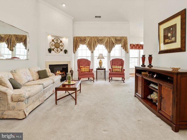 11110 Chambers Ct Unit N, Woodstock, MD 21163 - living area featuring a glass covered fireplace, ornamental molding, visible vents, and light colored carpet