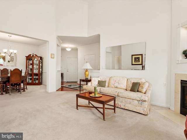 11110 Chambers Ct Unit N, Woodstock, MD 21163 - carpeted living area with a towering ceiling, crown molding, a fireplace, baseboards, and an inviting chandelier