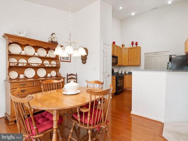 11110 Chambers Ct Unit N, Woodstock, MD 21163 - dining room featuring recessed lighting, light wood finished floors, a high ceiling, and a notable chandelier