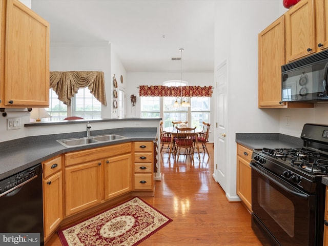 11110 Chambers Ct Unit N, Woodstock, MD 21163 - kitchen featuring light wood-type flooring, a sink, black appliances, and dark countertops