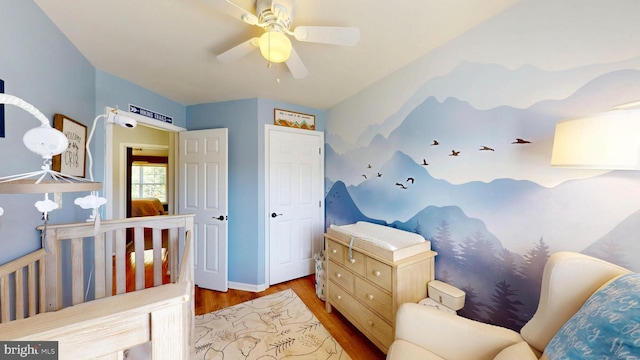 bedroom with a ceiling fan and wood finished floors