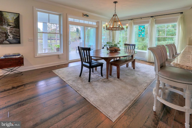 23280 Horse Island Rd, Lewes, DE 19958 - dining space featuring a chandelier, crown molding, dark wood-style floors, baseboards, and healthy amount of natural light
