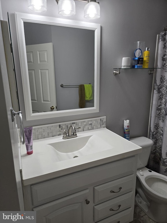 full bathroom featuring tasteful backsplash, vanity, and toilet