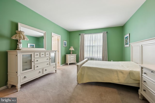 bedroom featuring baseboards and carpet