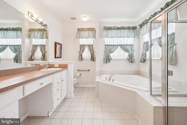 bathroom with tile patterned floors, a bath, vanity, toilet, and visible vents