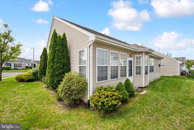 view of property exterior featuring a yard