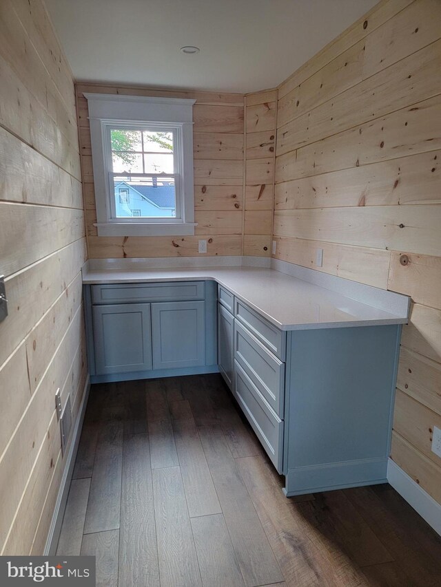 6555 Clagett Ave, Tracys Landing, MD 20779 - laundry area with wooden walls and dark wood-style floors