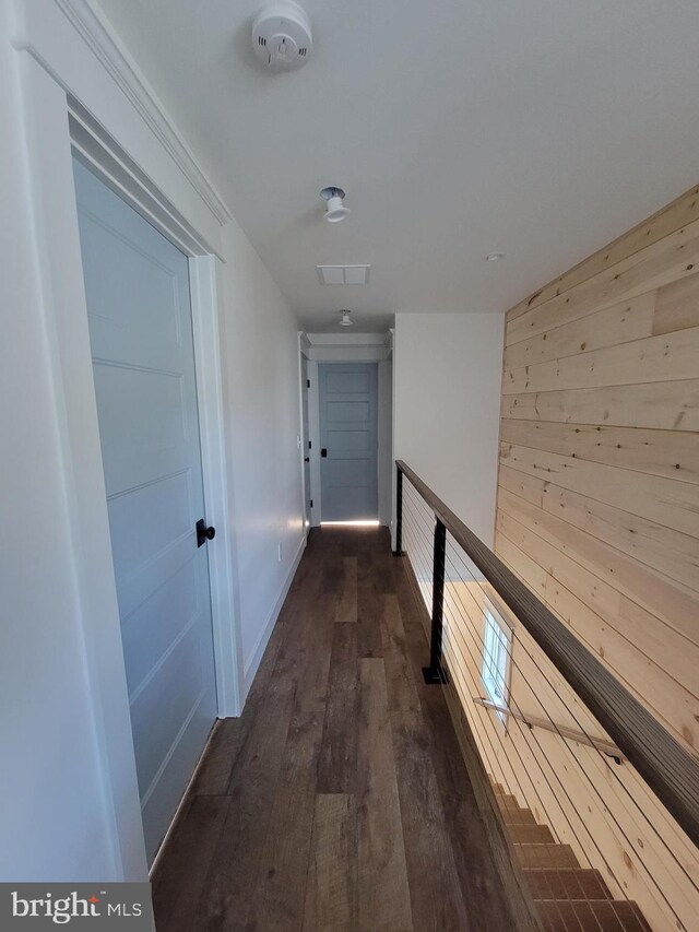 6555 Clagett Ave, Tracys Landing, MD 20779 - hall featuring dark wood-style flooring, visible vents, baseboards, and wooden walls