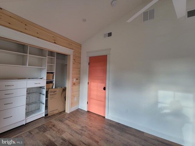6555 Clagett Ave, Tracys Landing, MD 20779 - unfurnished bedroom featuring dark wood-style flooring, visible vents, baseboards, and high vaulted ceiling