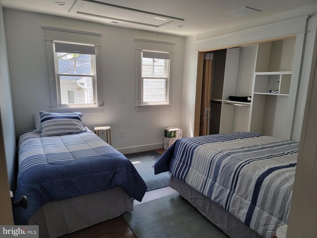 6555 Clagett Ave, Tracys Landing, MD 20779 - bedroom featuring wood finished floors, attic access, baseboards, and visible vents