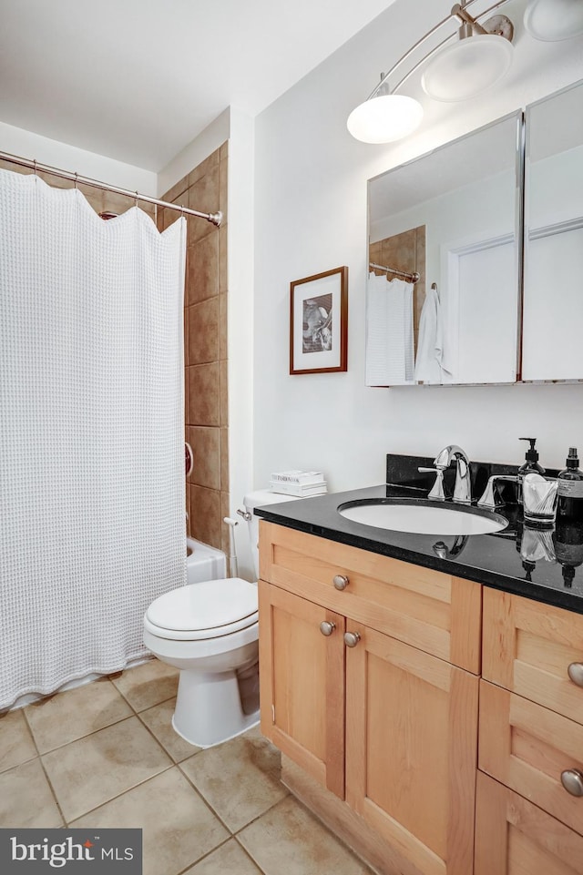 bathroom with tile patterned flooring, shower / tub combo, vanity, and toilet
