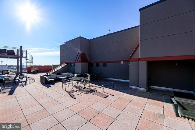 view of patio / terrace with outdoor dining space and stairs