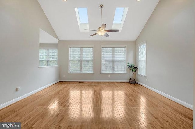 13404 Fieldstone Way, Gainesville, VA 20155 - spare room featuring a skylight, lofted ceiling, healthy amount of natural light, baseboards, and wood finished floors