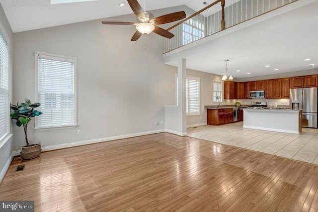 13404 Fieldstone Way, Gainesville, VA 20155 - unfurnished living room with light wood-type flooring, high vaulted ceiling, healthy amount of natural light, and recessed lighting