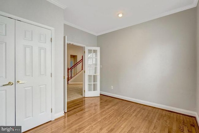 13404 Fieldstone Way, Gainesville, VA 20155 - empty room featuring baseboards, light wood-style floors, crown molding, stairway, and french doors