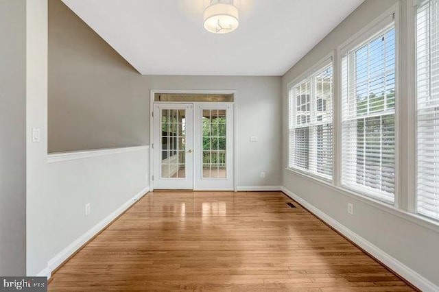 13404 Fieldstone Way, Gainesville, VA 20155 - spare room with plenty of natural light, wood finished floors, and french doors