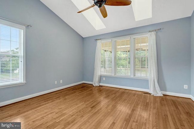 13404 Fieldstone Way, Gainesville, VA 20155 - empty room with ceiling fan, vaulted ceiling, healthy amount of natural light, a skylight, and wood finished floors