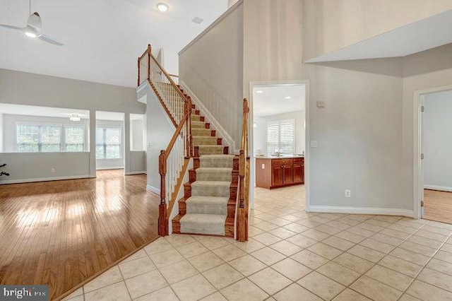 13404 Fieldstone Way, Gainesville, VA 20155 - stairs featuring baseboards, tile patterned floors, a high ceiling, and a ceiling fan