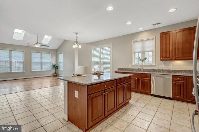 13404 Fieldstone Way, Gainesville, VA 20155 - kitchen featuring stainless steel dishwasher, a skylight, light tile patterned flooring, vaulted ceiling, and recessed lighting