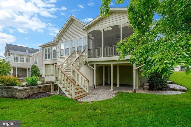 13404 Fieldstone Way, Gainesville, VA 20155 - rear view of property featuring a lawn, stairs, and a sunroom