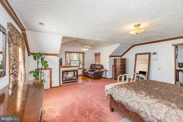 carpeted bedroom featuring crown molding, a multi sided fireplace, a textured ceiling, visible vents, and vaulted ceiling
