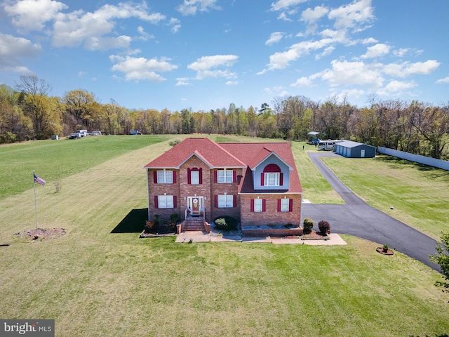 view of front of property with a front yard and brick siding