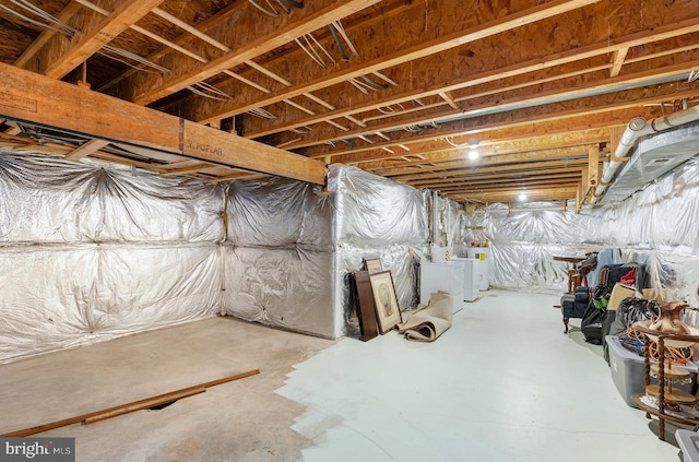 unfinished below grade area featuring separate washer and dryer