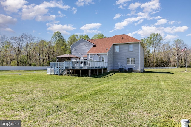 rear view of house featuring a gazebo, central AC unit, a deck, and a lawn