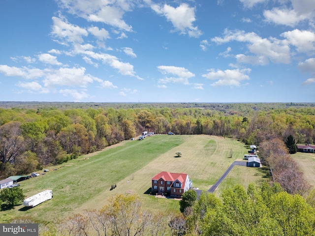 aerial view featuring a forest view and a rural view