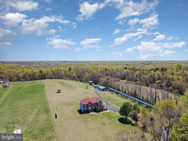 drone / aerial view featuring a wooded view and a rural view
