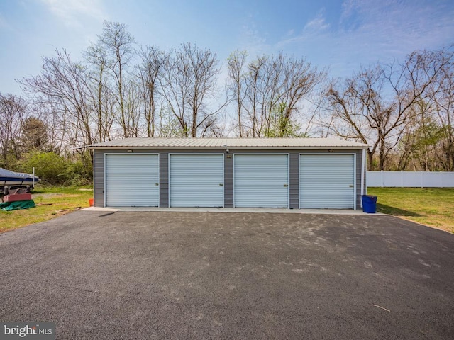 detached garage featuring fence