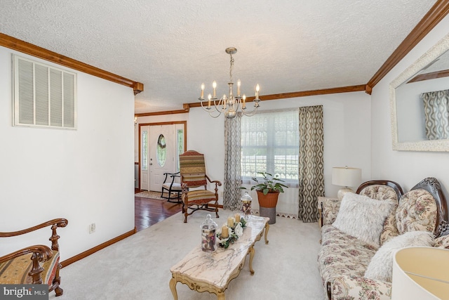 living area featuring carpet flooring, an inviting chandelier, ornamental molding, and visible vents