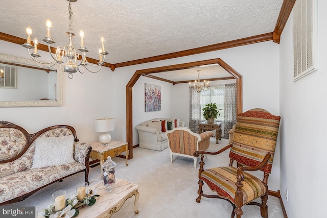 carpeted living room with baseboards, an inviting chandelier, ornamental molding, and a textured ceiling