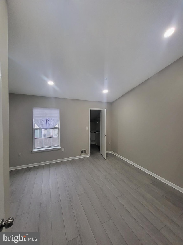 unfurnished room with visible vents, baseboards, recessed lighting, and wood finished floors