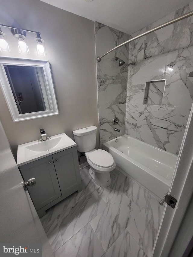bathroom with toilet, vanity, marble finish floor, and shower / bathtub combination