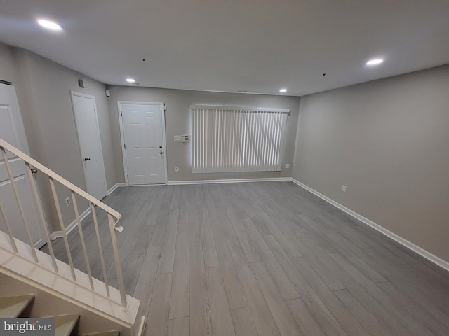 entryway with stairway, baseboards, recessed lighting, and wood finished floors