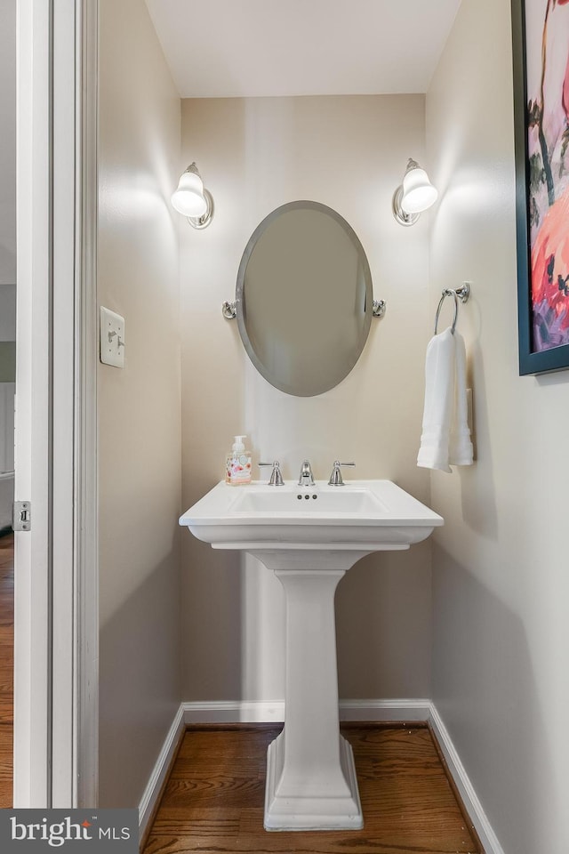 bathroom with wood finished floors and baseboards